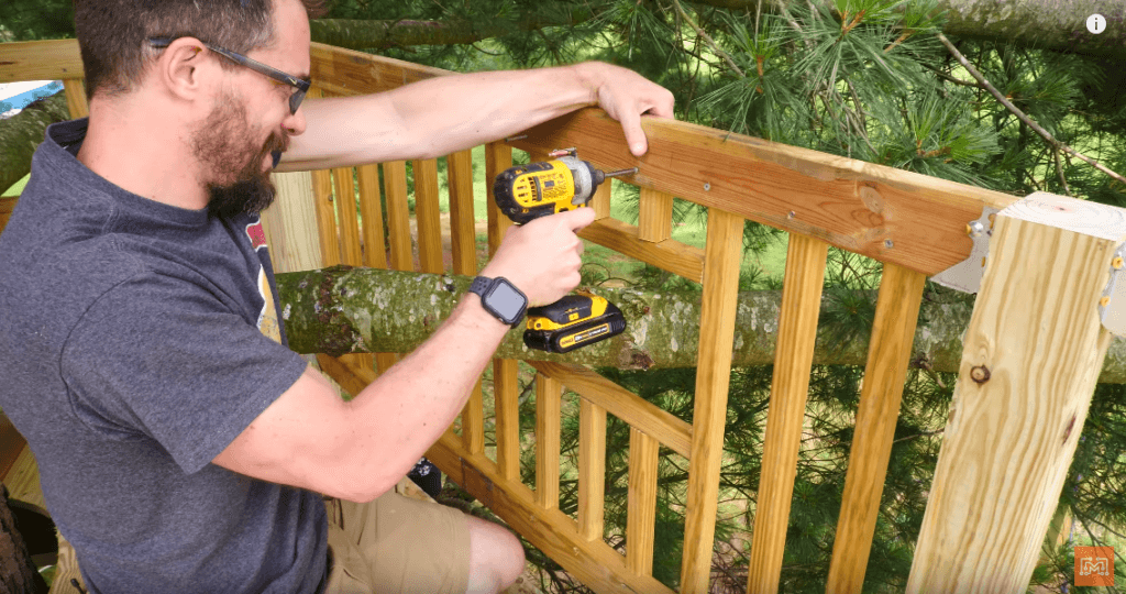 A DIY'er is shown Installing Safety Rails in a Family Treehouse.